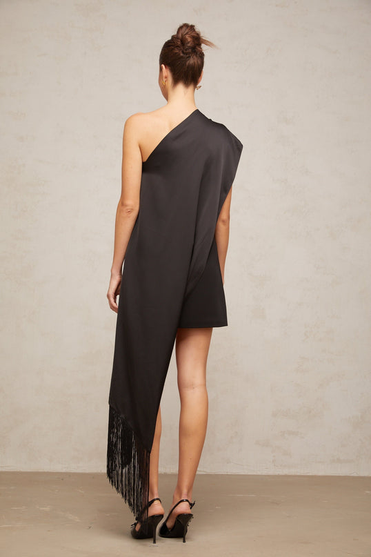 A woman wearing a short black dress with one shoulder strap suitable for Valentines Day