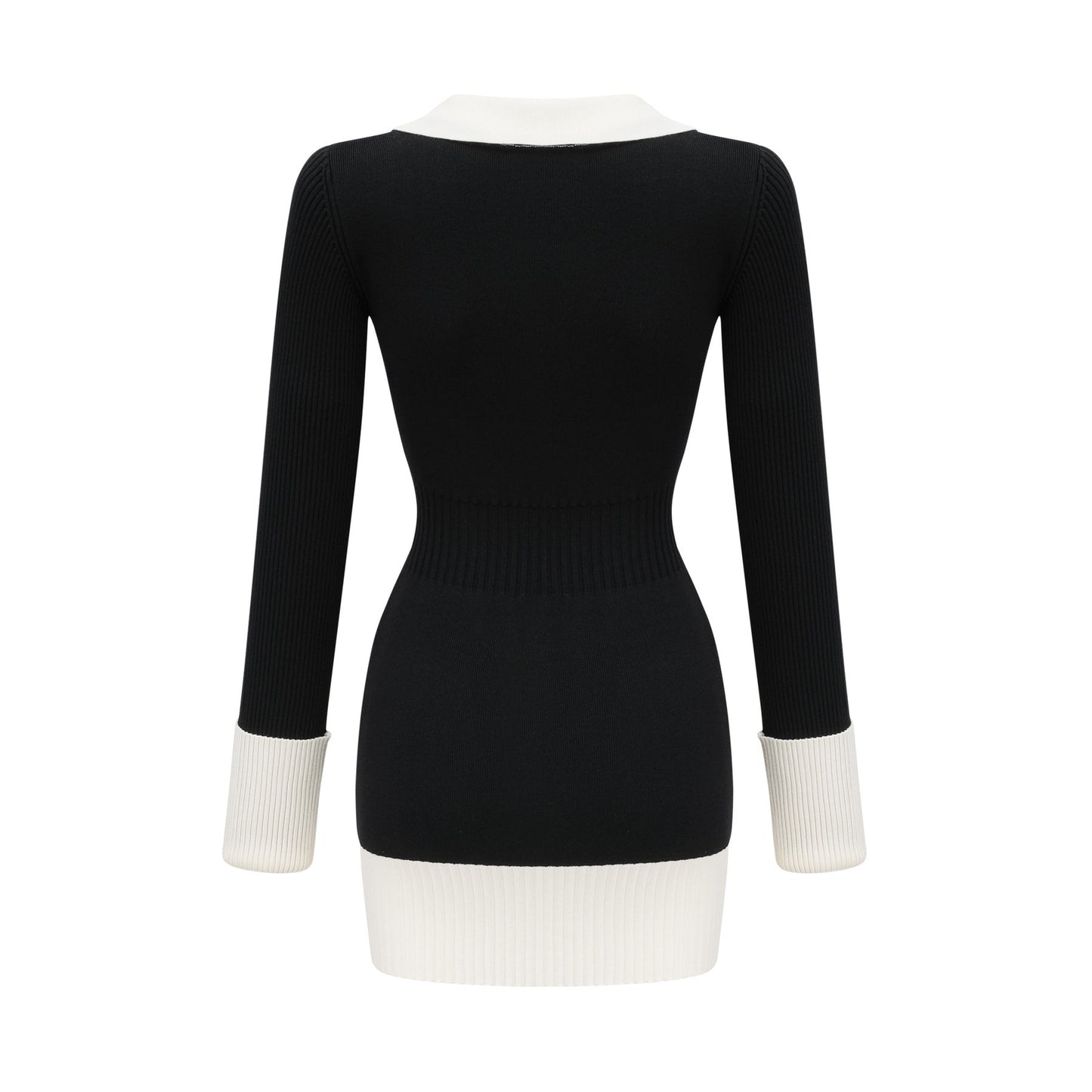 A woman wearing a short wool dress with color blocks and ribbed texture featuring long sleeves and a high neckline