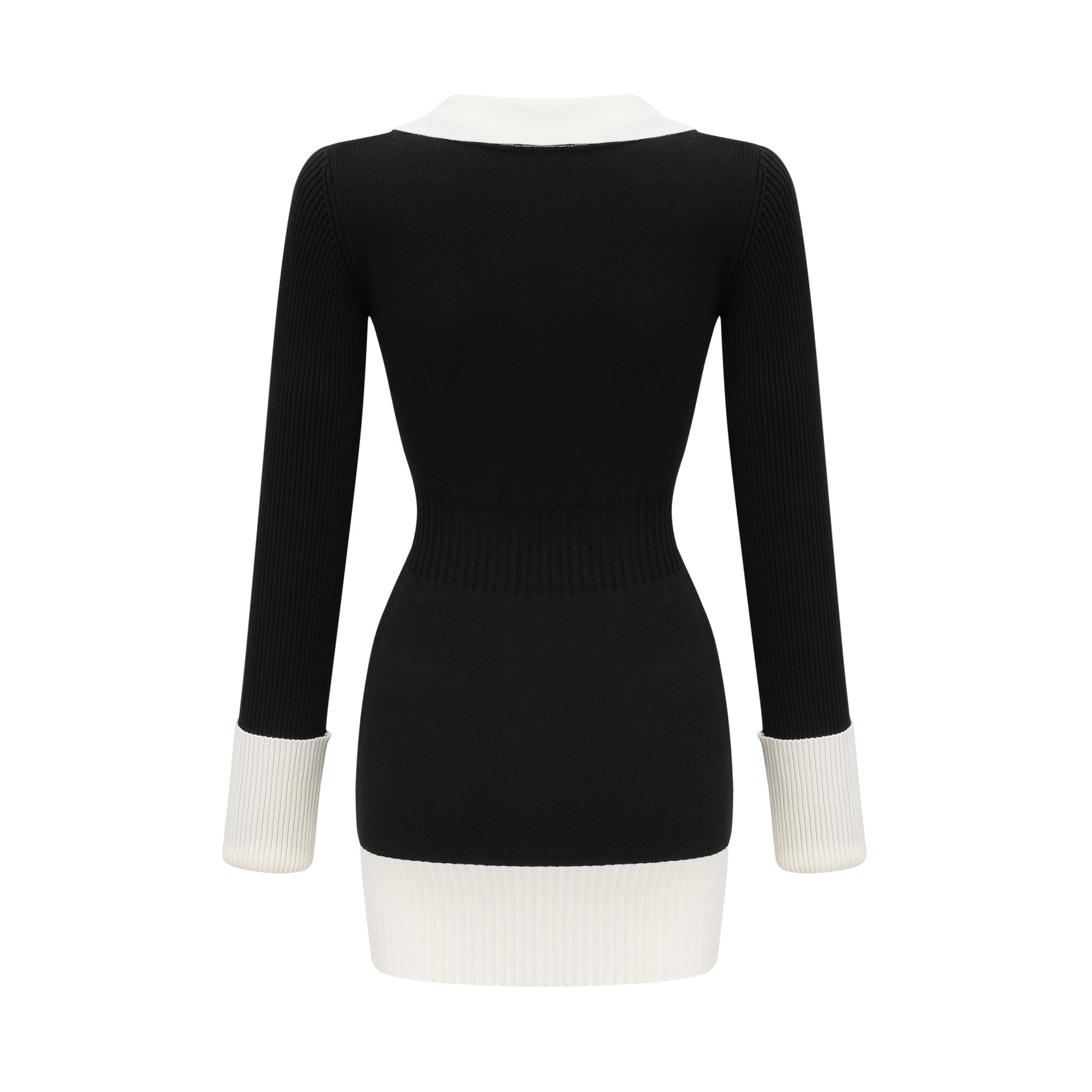 A woman wearing a short wool dress with color blocks and ribbed texture featuring long sleeves and a high neckline