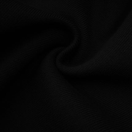 A woman wearing a short wool dress with colorblocked panels in contrasting shades and a ribbed knit texture The dress has long sleeves and a fitted silhouette ending above the knees