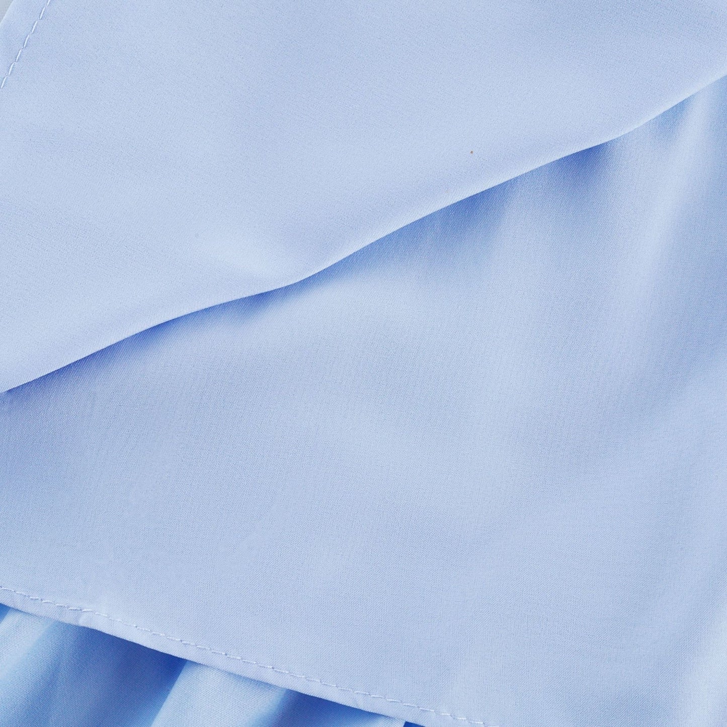 A woman wearing a shoulderfree tiered midi dress with a flowy silhouette in a soft fabric