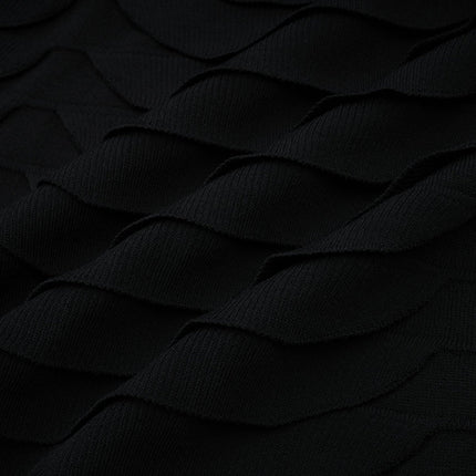 A woman wearing a snakepattern midi dress with godet inserts flared skirt and long sleeves standing in a neutral pose