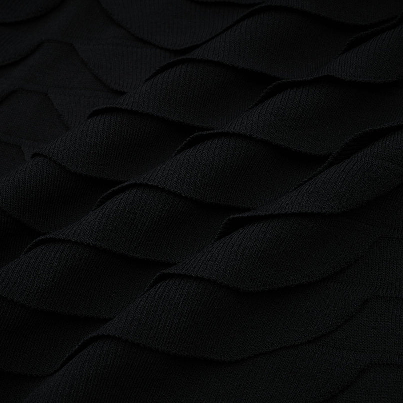 A woman wearing a snakepattern midi dress with godet inserts flared skirt and long sleeves standing in a neutral pose