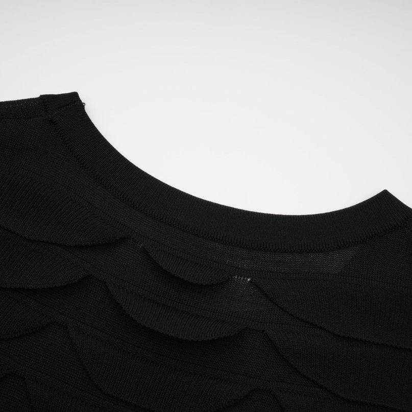 A woman wearing a snakepattern midi dress with godet inserts for a flared silhouette the dress features a fitted bodice and long sleeves