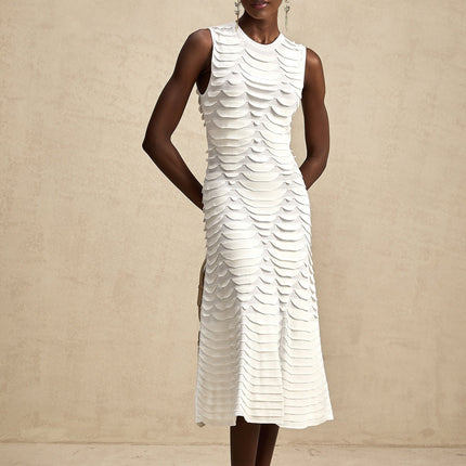 A woman wearing a snakeskin patterned midi dress with a flared godet skirt silhouette