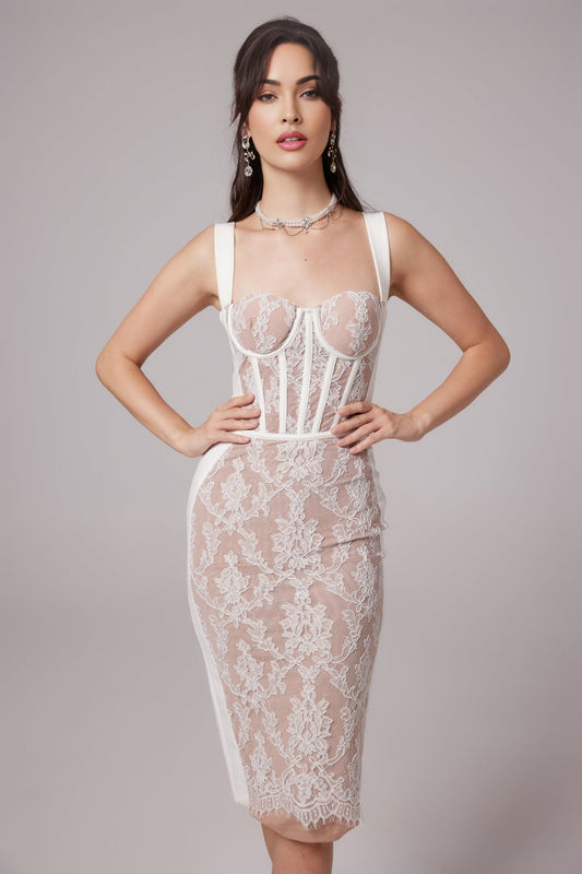 A woman wearing a strapless bandage style midi dress in a bustier design colored titania posing against a plain background