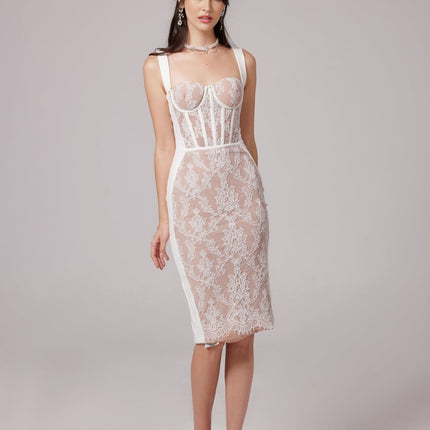 A woman wearing a strapless beige midi dress with a bandage style fabric and bustierlike top