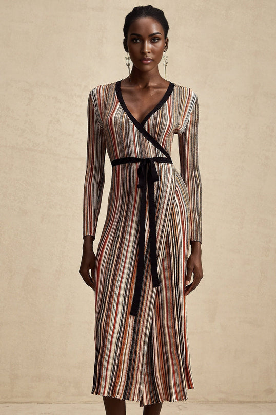 A woman wearing a striped metallic midi dress with a wrap design The dress has a shimmering effect and fits closely to the body emphasizing the waist The stripes create a flattering pattern across the dress