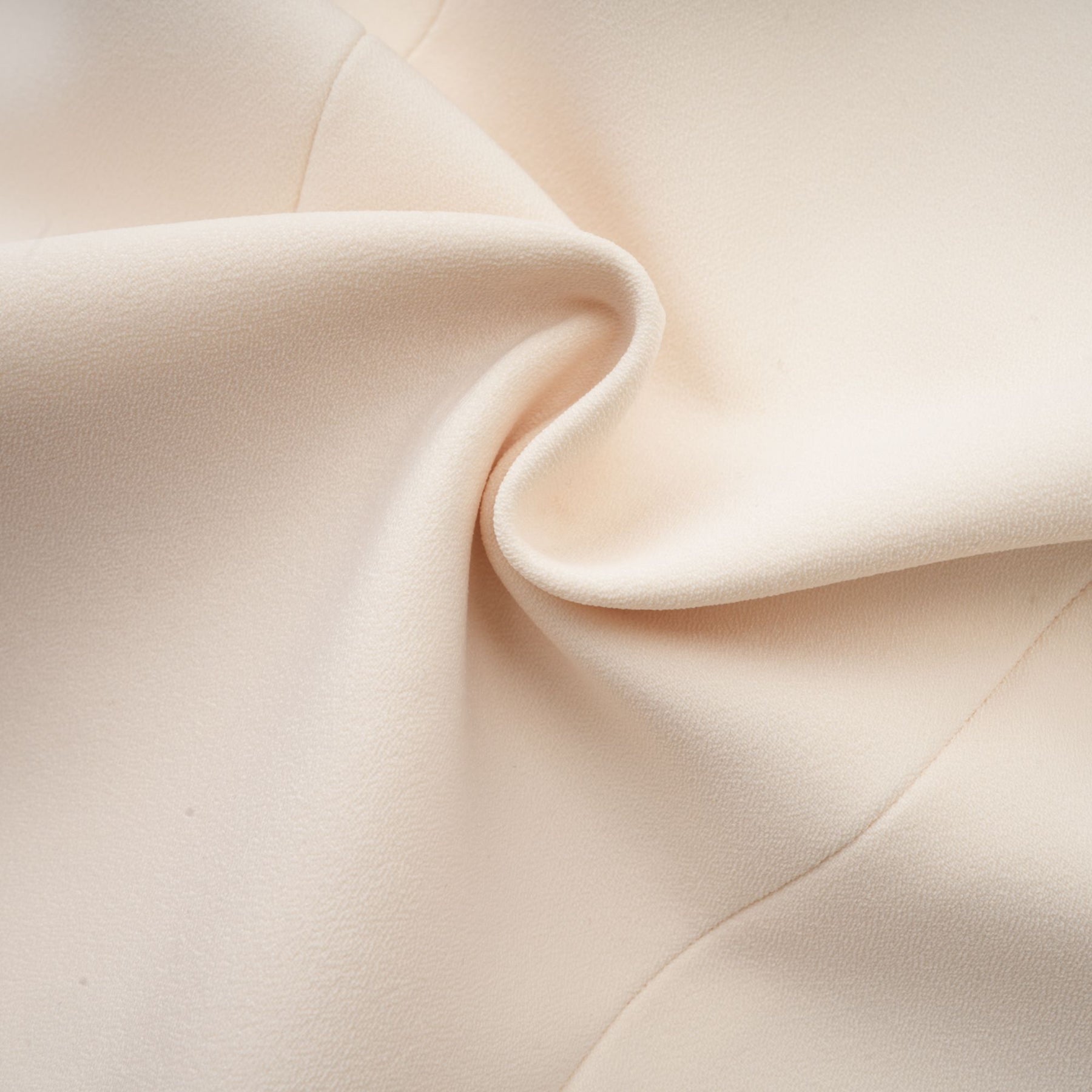 A woman wearing a stylish blazer dress adorned with shimmering sequins and embellishments