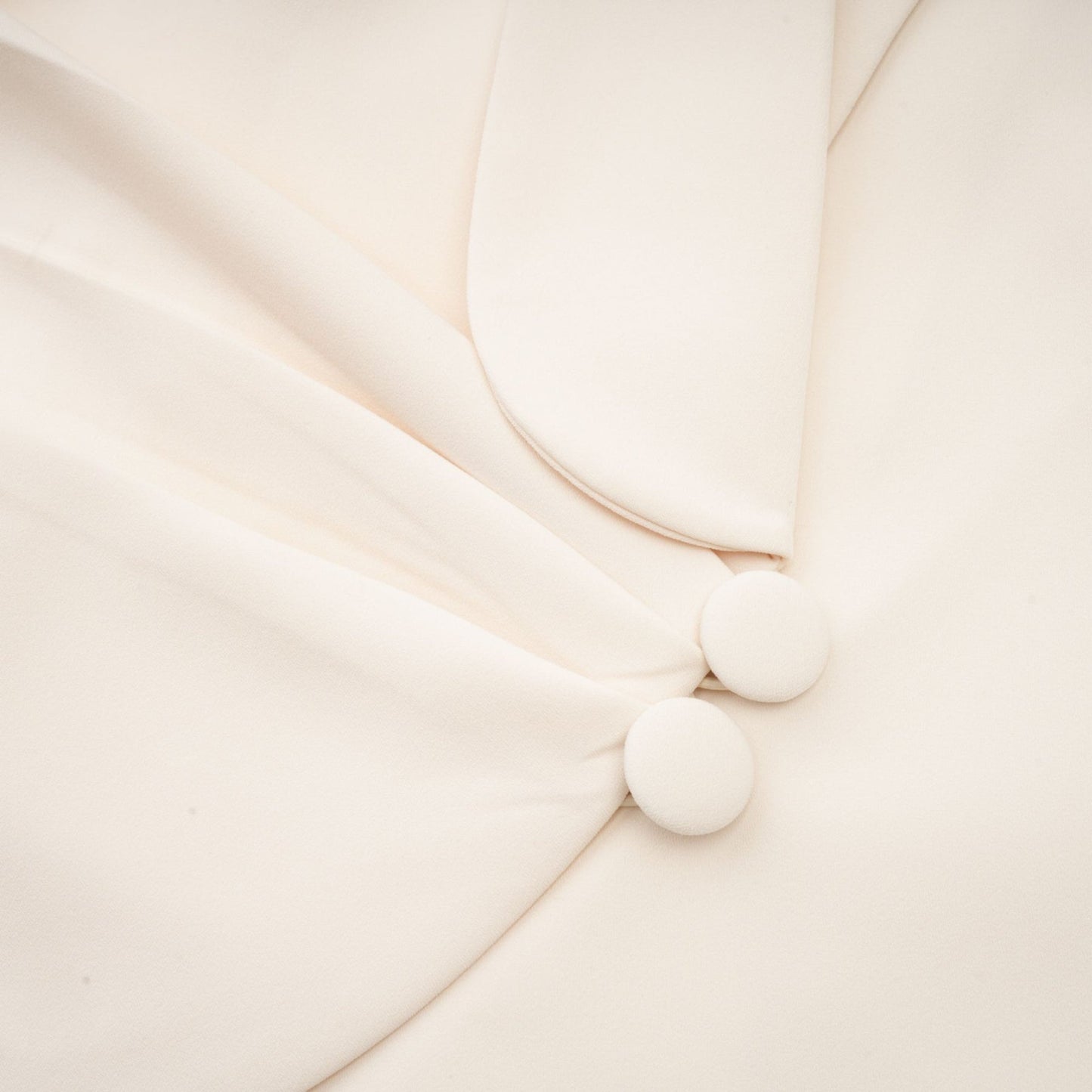 A woman wearing a stylish blazer dress covered in shimmering sequins with embellished details