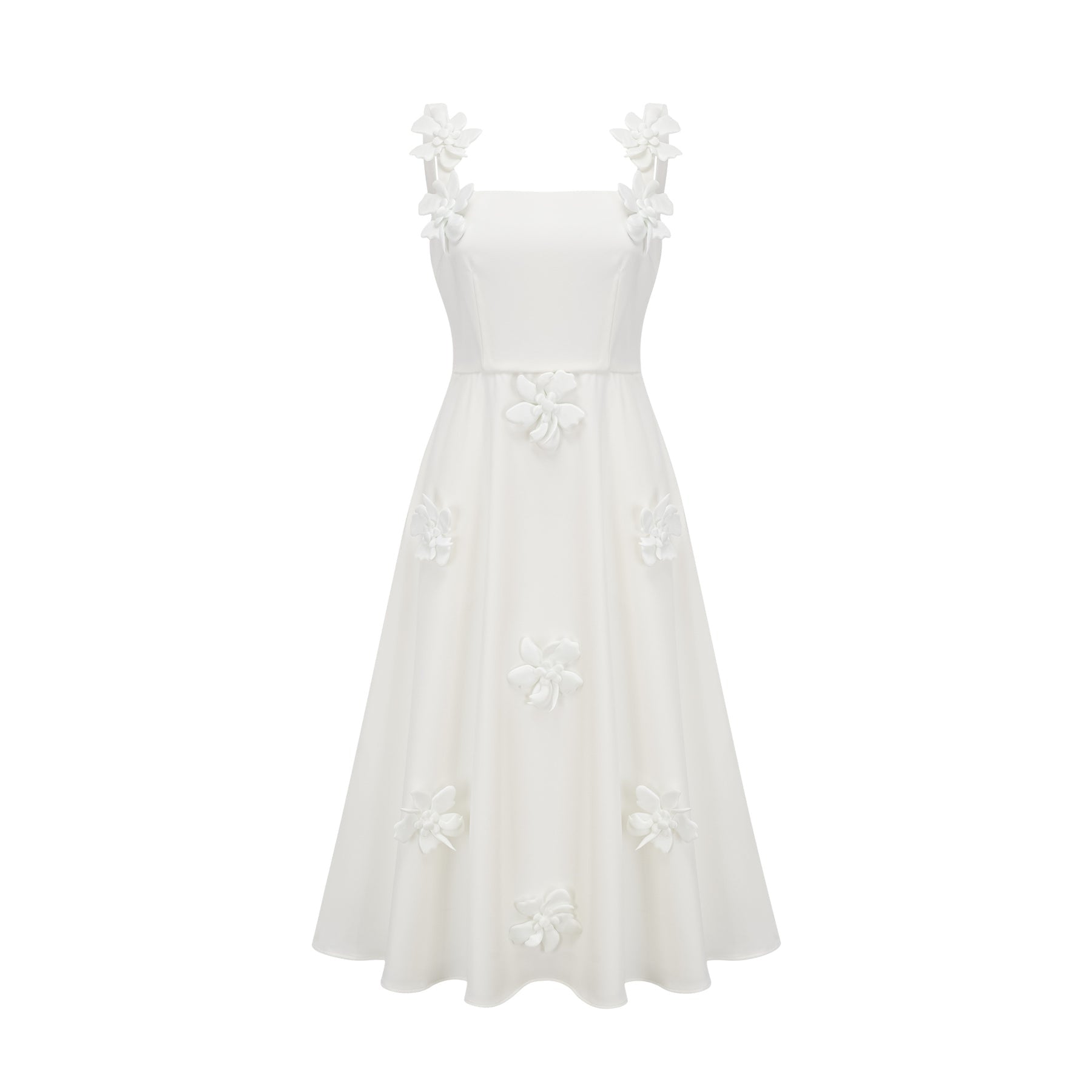 A woman wearing a white midi dress with a square neckline and faux flower embellishments standing in a neutral background
