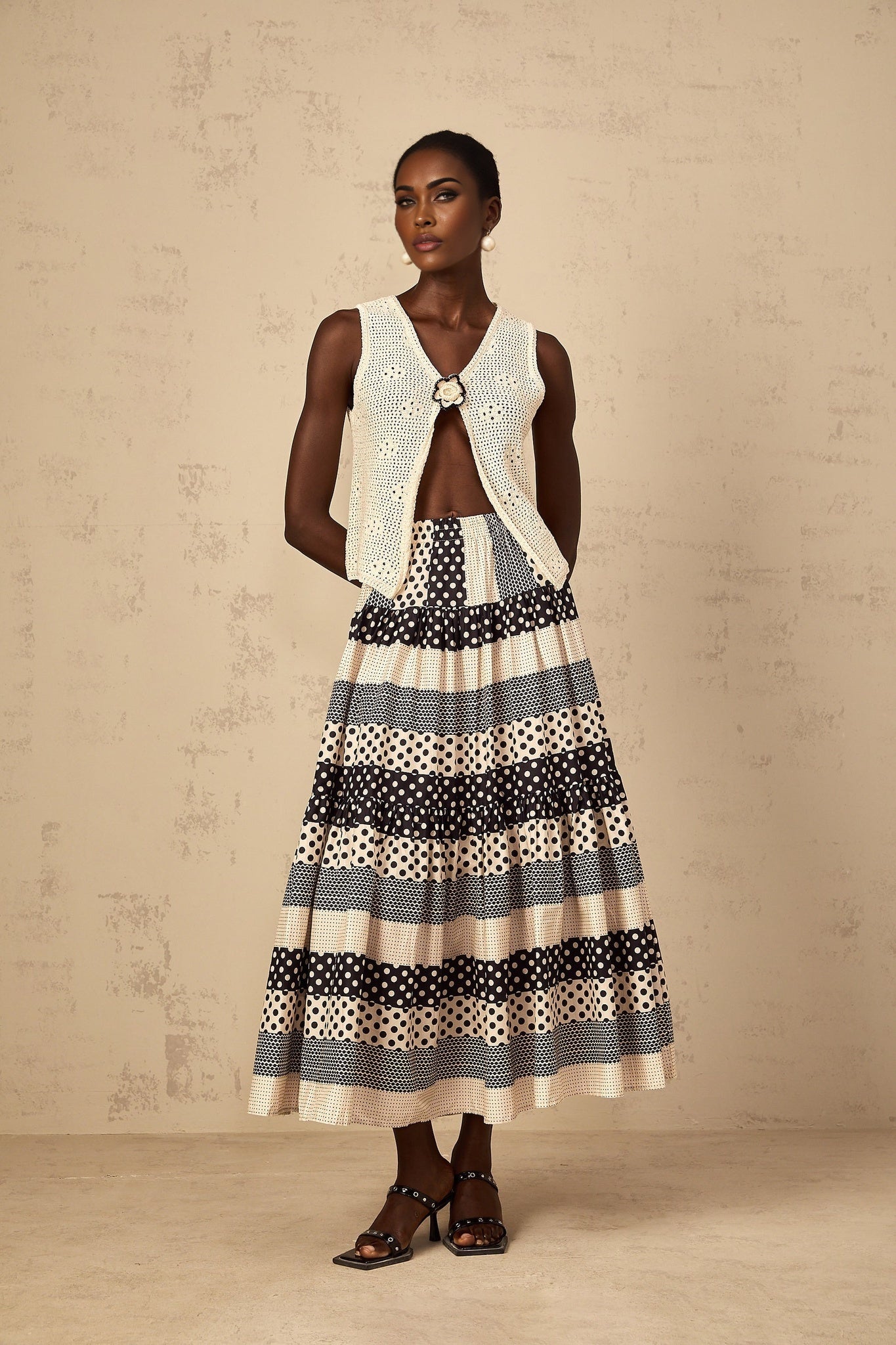A womens skirt featuring color block design with shirred waist and polka dot pattern