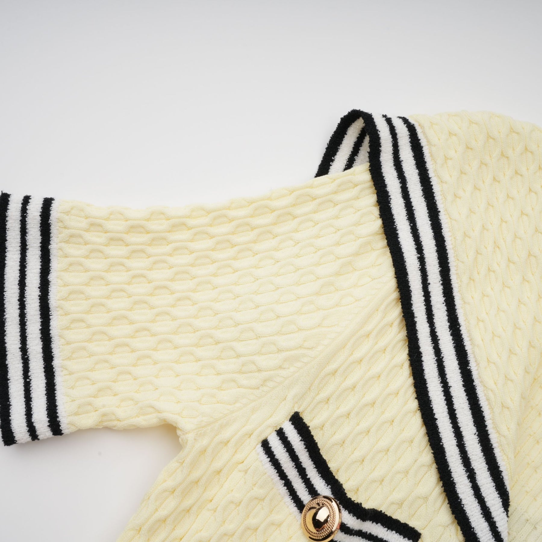 A yellow knitted dress with a sailor collar featuring a Madeleine style design