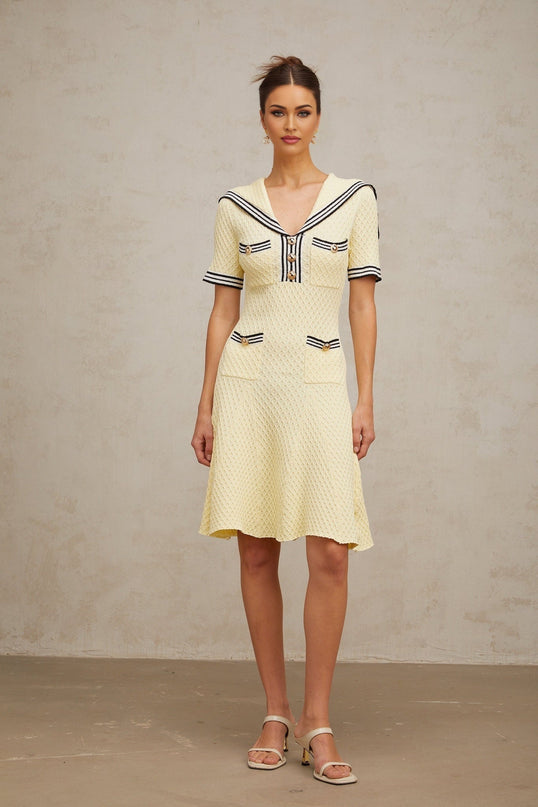 A yellow knitted dress with a sailor collar in a Madeleine style