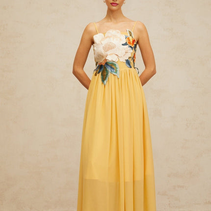 A yellow maxi dress with floral embroidery and shirred details named Josette