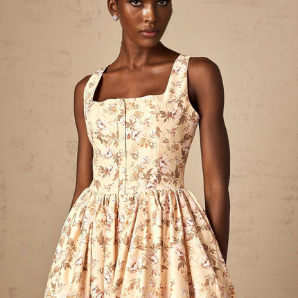 A yellow midi dress with a floral print pattern and button detailing