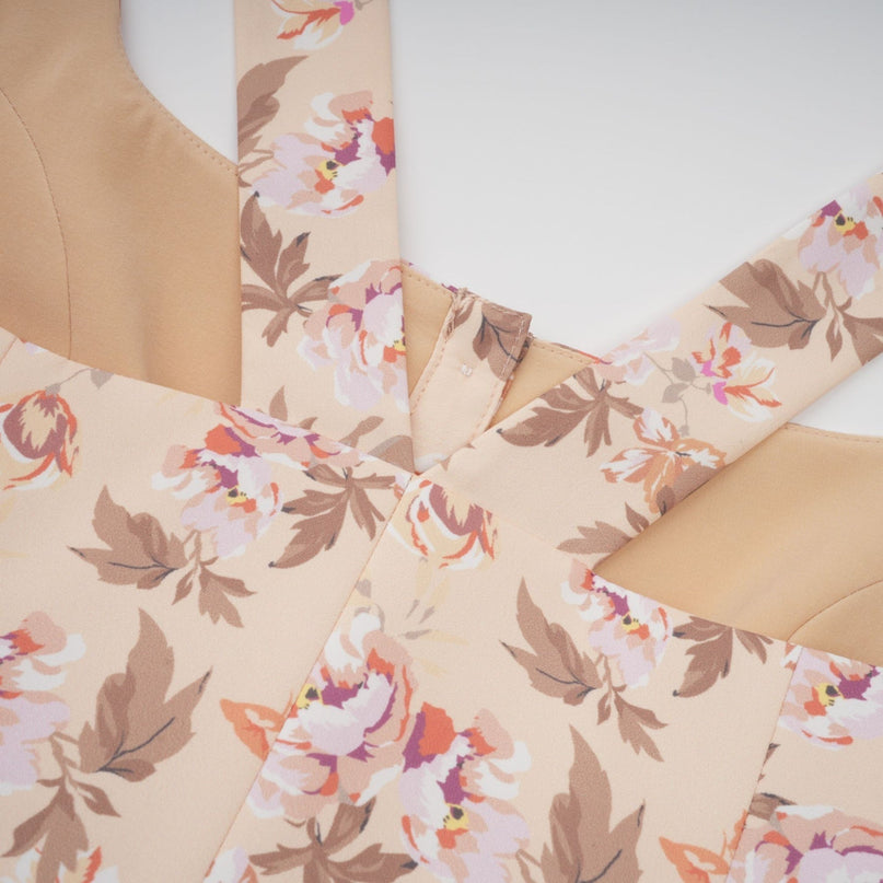 A yellow midi dress with a floral print pattern and button detailing