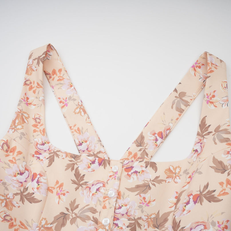 A yellow midi dress with a floral print pattern and button details