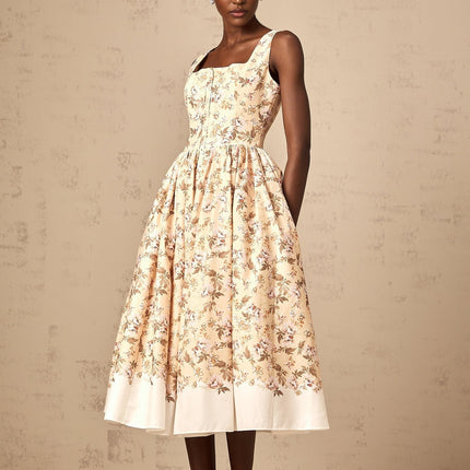 A yellow midi dress with a floral print pattern and button details