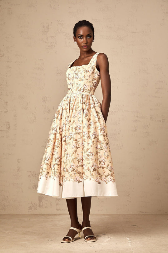 A yellow midi dress with a floral print pattern and button details