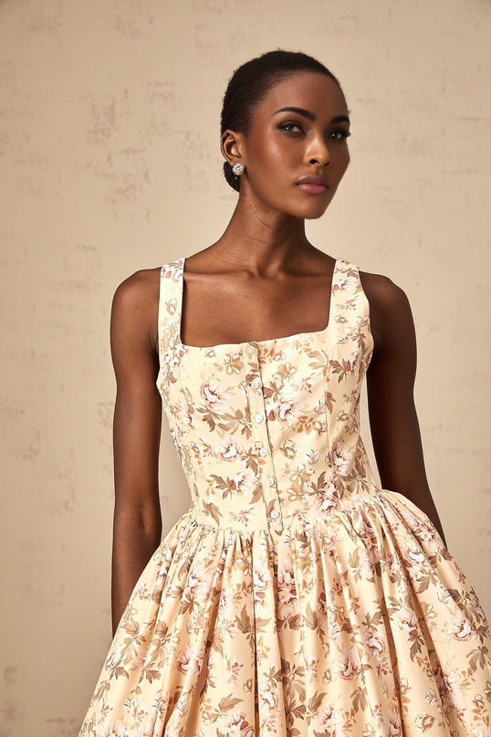 A yellow midi dress with a floral print pattern and button details