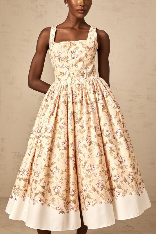 A yellow midi dress with a floral print pattern and button details