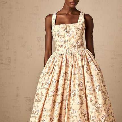 A yellow midi dress with a floral print pattern and buttons down the front