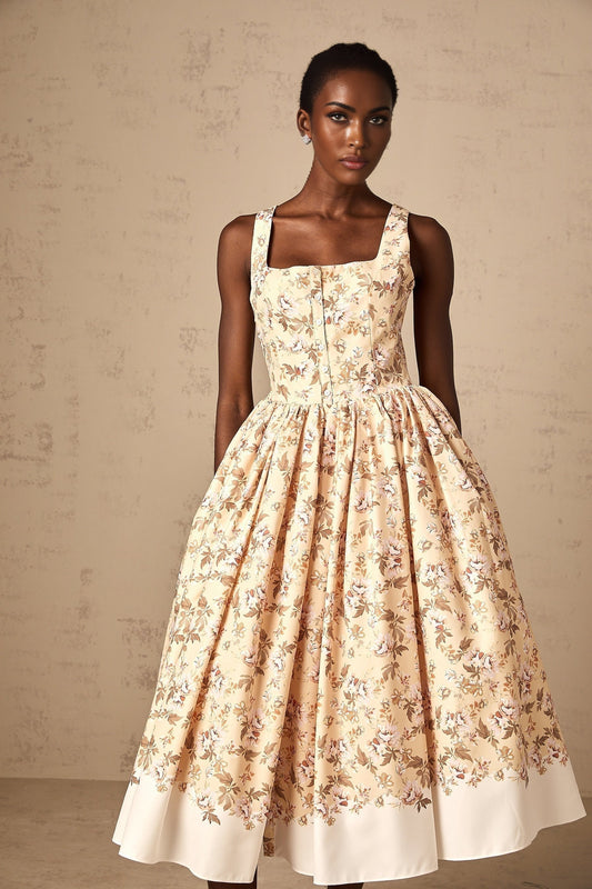 A yellow midi dress with a floral print pattern and buttons down the front