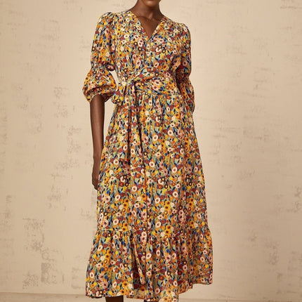 A yellow midi dress with a floral print pattern and Vneck design called Eliane
