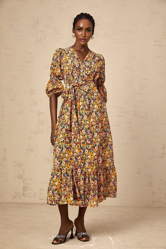 A yellow midi dress with a floral print pattern and Vneck design called Eliane