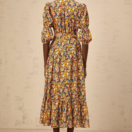 A yellow midi dress with a floral print pattern and Vneck design named Éliane
