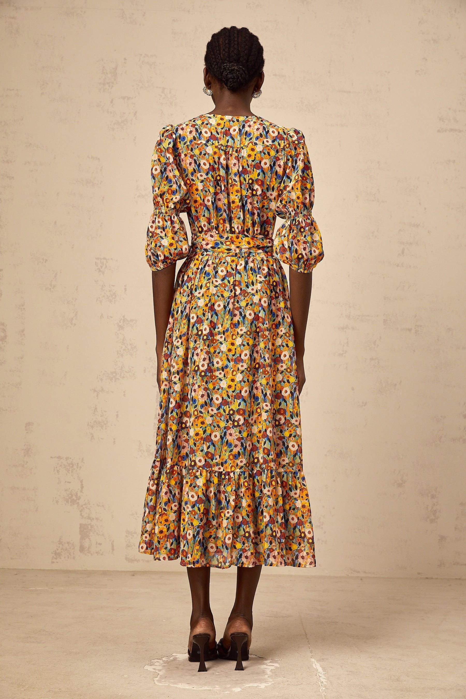 A yellow midi dress with a floral print pattern and Vneck design named Éliane