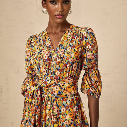 A yellow midi dress with a floral print pattern and Vneck design named Éliane