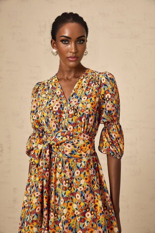 A yellow midi dress with a floral print pattern and Vneck design named Éliane