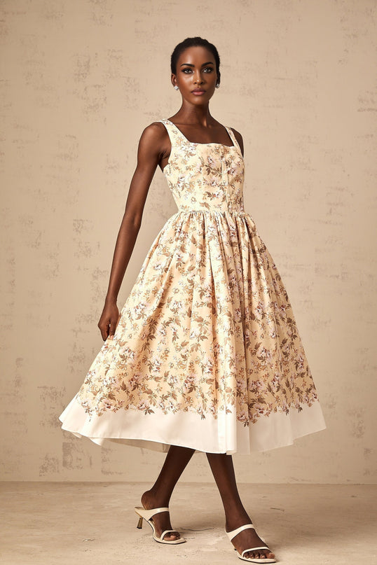 A yellow midi dress with a floral print pattern featuring buttons and a feminine silhouette