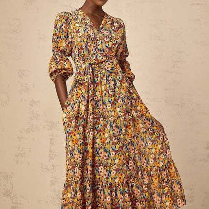 A yellow midi dress with floral print and Vneck design called Eliane