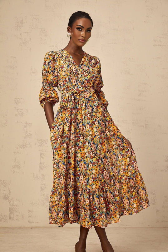 A yellow midi dress with floral print and Vneck design called Eliane