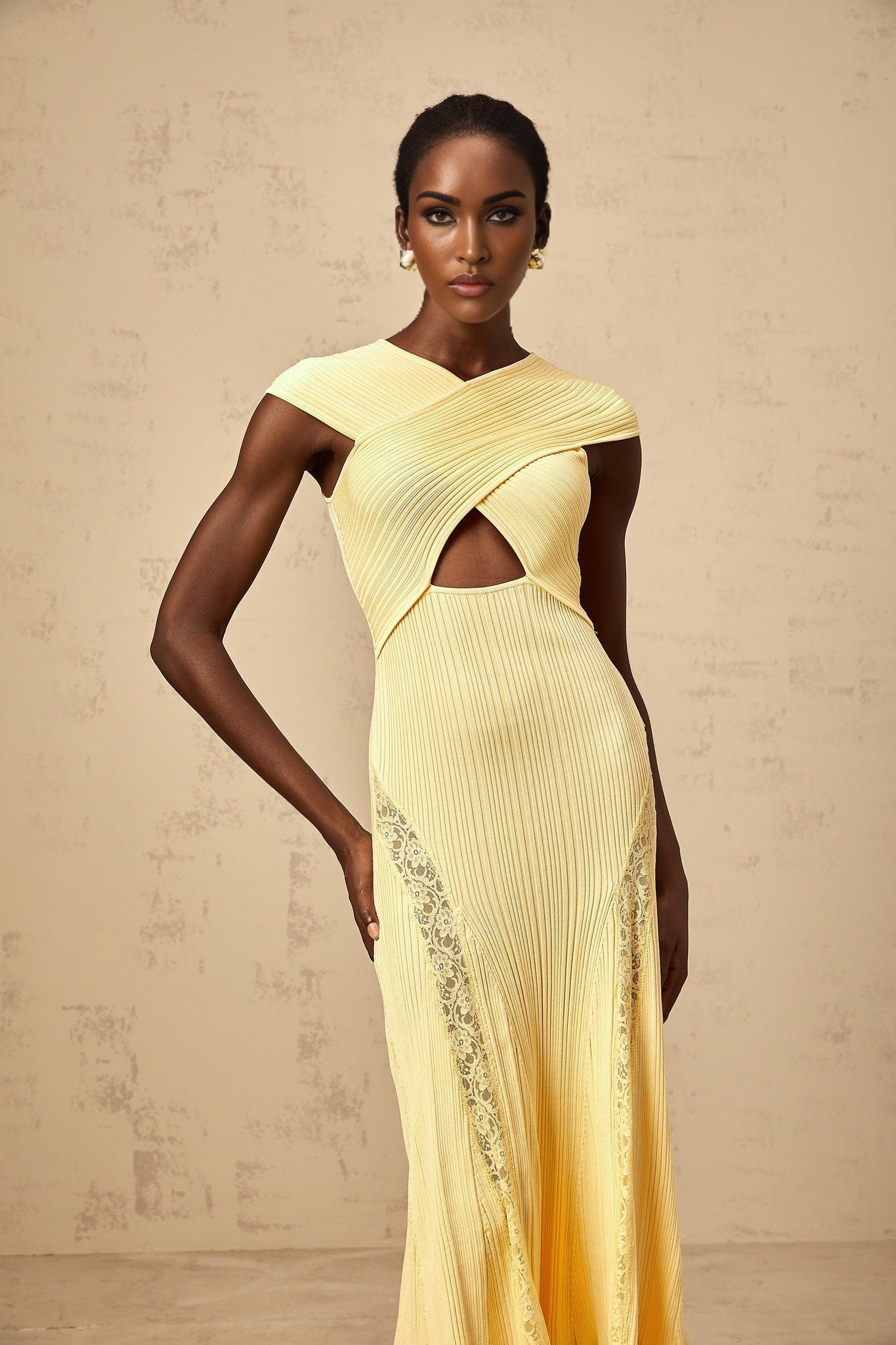 A yellow midi dress with lace panels and ribbed knit fabric featuring a fitted silhouette and delicate lace detailing