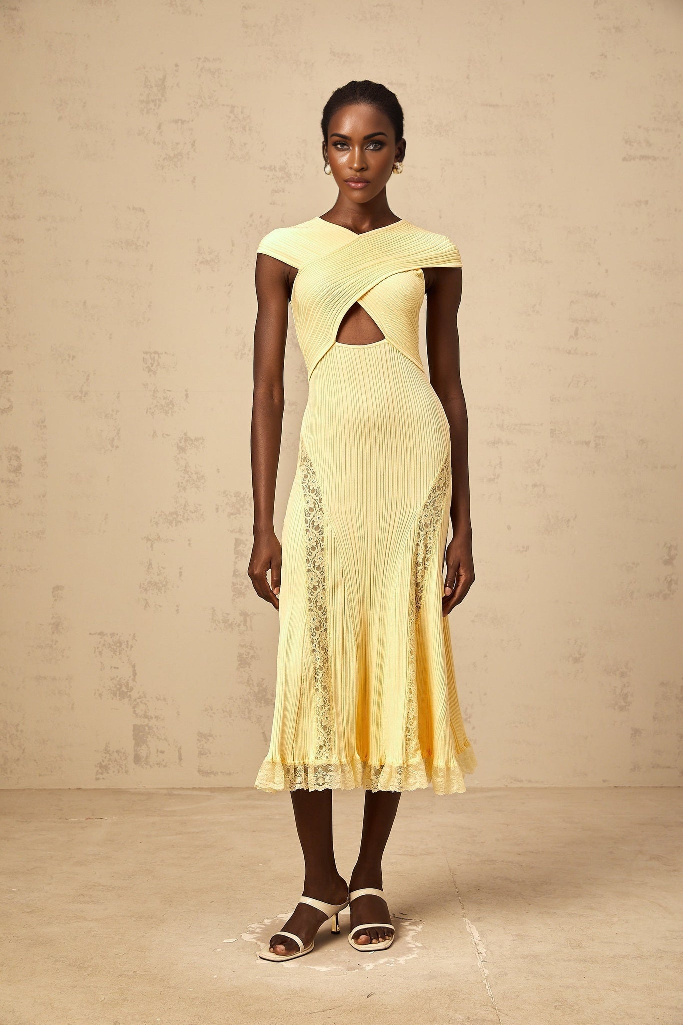 A yellow midi dress with ribbed knit fabric and lace panel details featuring a fitted silhouette and long sleeves