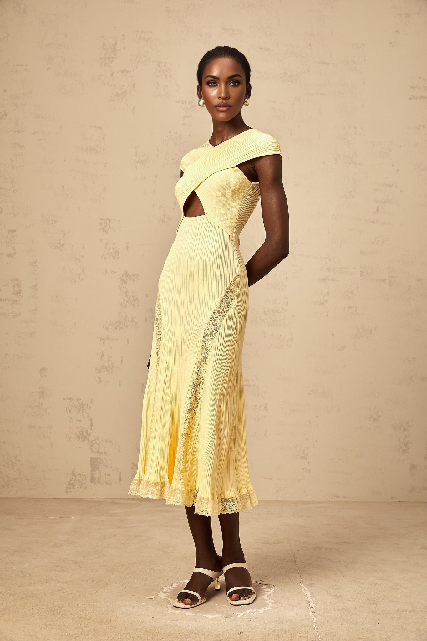 A yellow ribbed knit midi dress with lace panel detailing featuring a fitted silhouette and sleeveless design