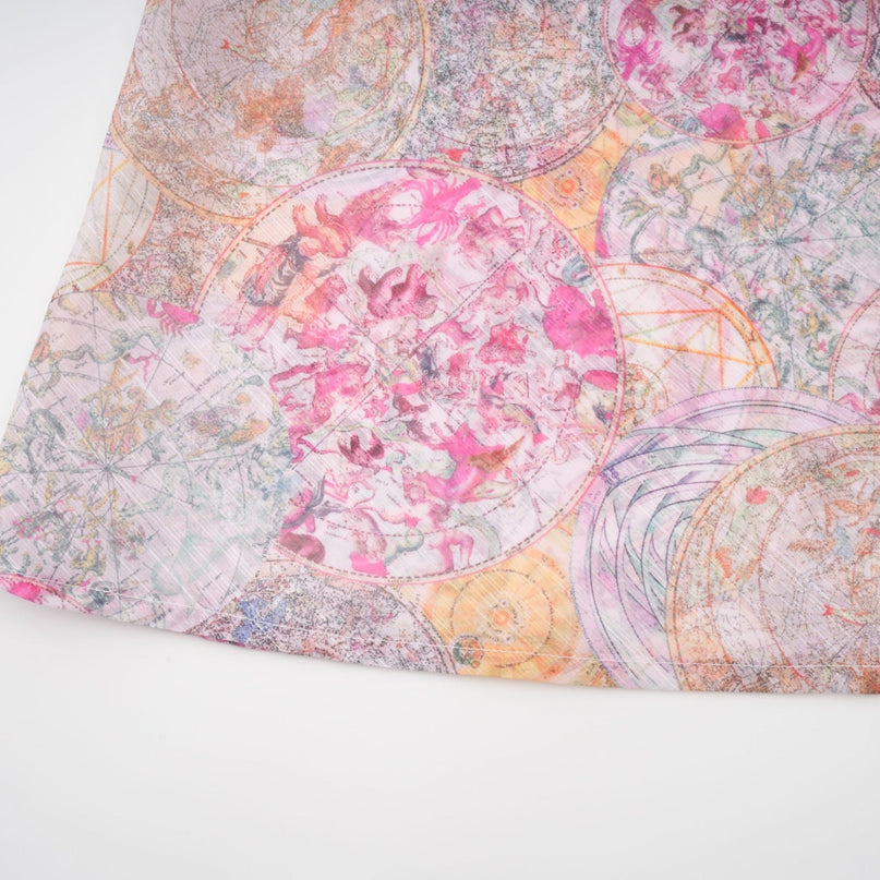 A young girl wearing a matching cherry pink shirt and skirt set with a pattern print design The shirt has short sleeves and the skirt falls just above the knee