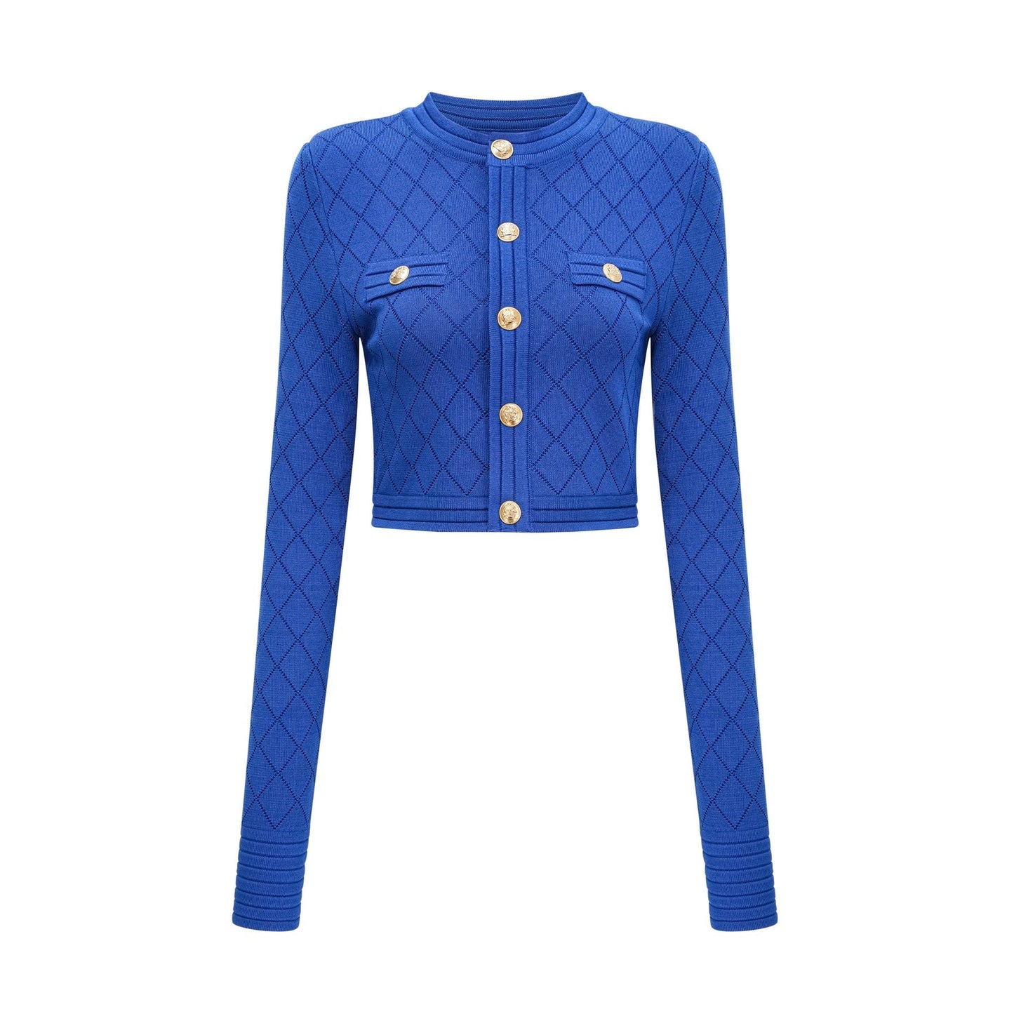 A young woman wearing a blue knitted two piece outfit consisting of a long sleeve top with button details and a matching skirt