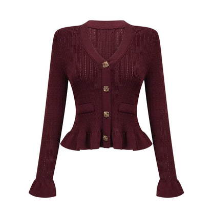 A young woman wearing a matching red knit set consisting of a ruffled top and skirt The top features short sleeves and a scoop neckline while the skirt is fitted with a ruffled hem The outfit has a textured knit pattern throughout