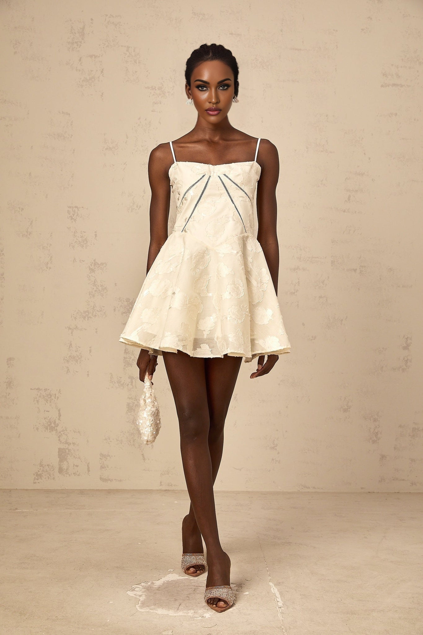 Adabella white mini dress with floral jacquard pattern on fabric model wearing dress against plain background