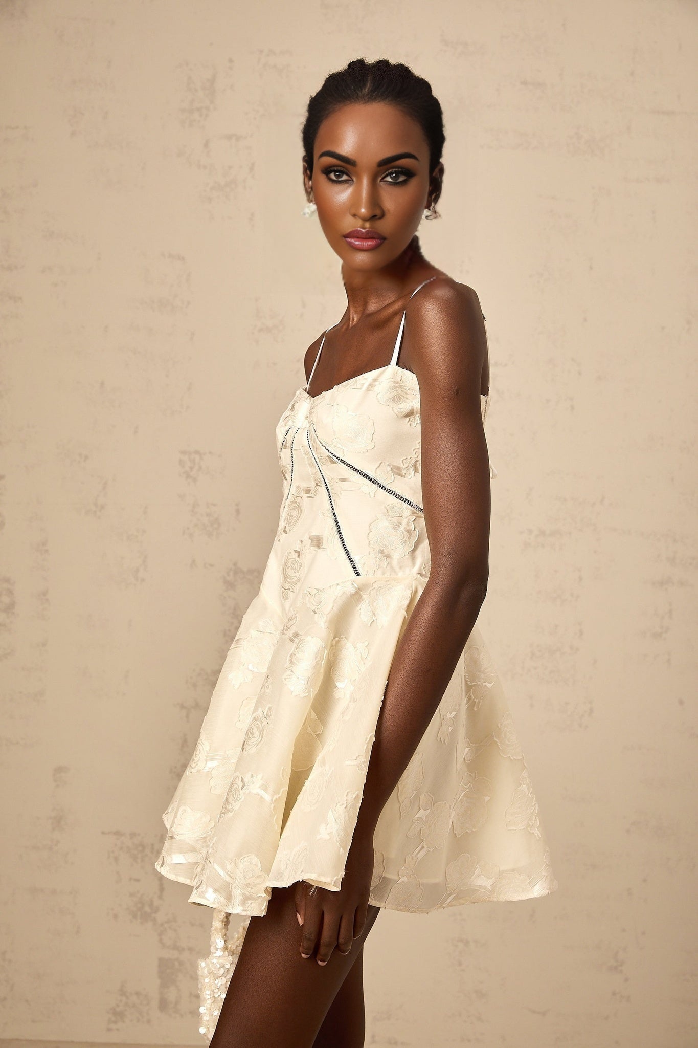 Adabella white mini dress with floral jacquard pattern on fabric shown against plain background