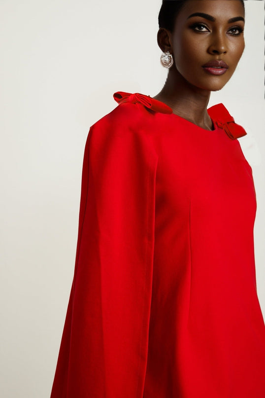 Alexandra Bright Red Mini Dress boat neck long sleeves cape design bow detailing side zip fastening thigh-length silhouette luxurious blend of 91% Rayon and 9% Silk timeless masterpiece