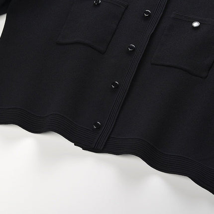 Alma wearing black cropped top and flared skirt with pearl collar for fall or spring events
