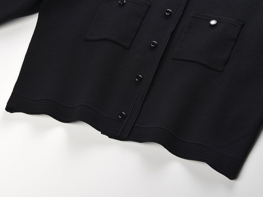 Alma wearing black cropped top and flared skirt with pearl collar for fall or spring events