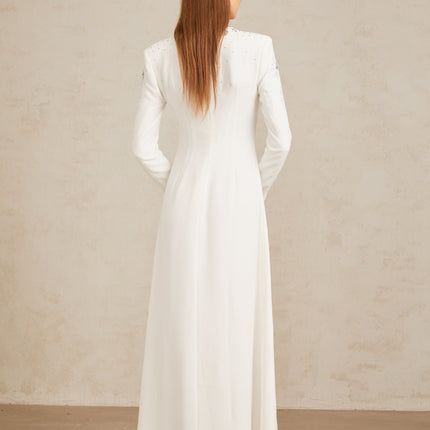 Aloïse White Embellished Maxi Gown in White color with crystal and rhinestone embellishments, round neck, long sleeves, fitted waistline, and flared hem