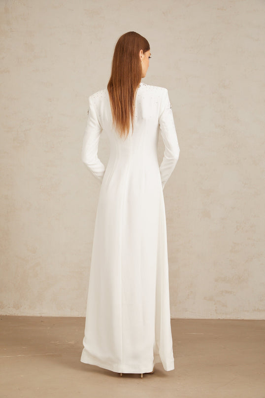 Aloïse White Embellished Maxi Gown in White color with crystal and rhinestone embellishments, round neck, long sleeves, fitted waistline, and flared hem